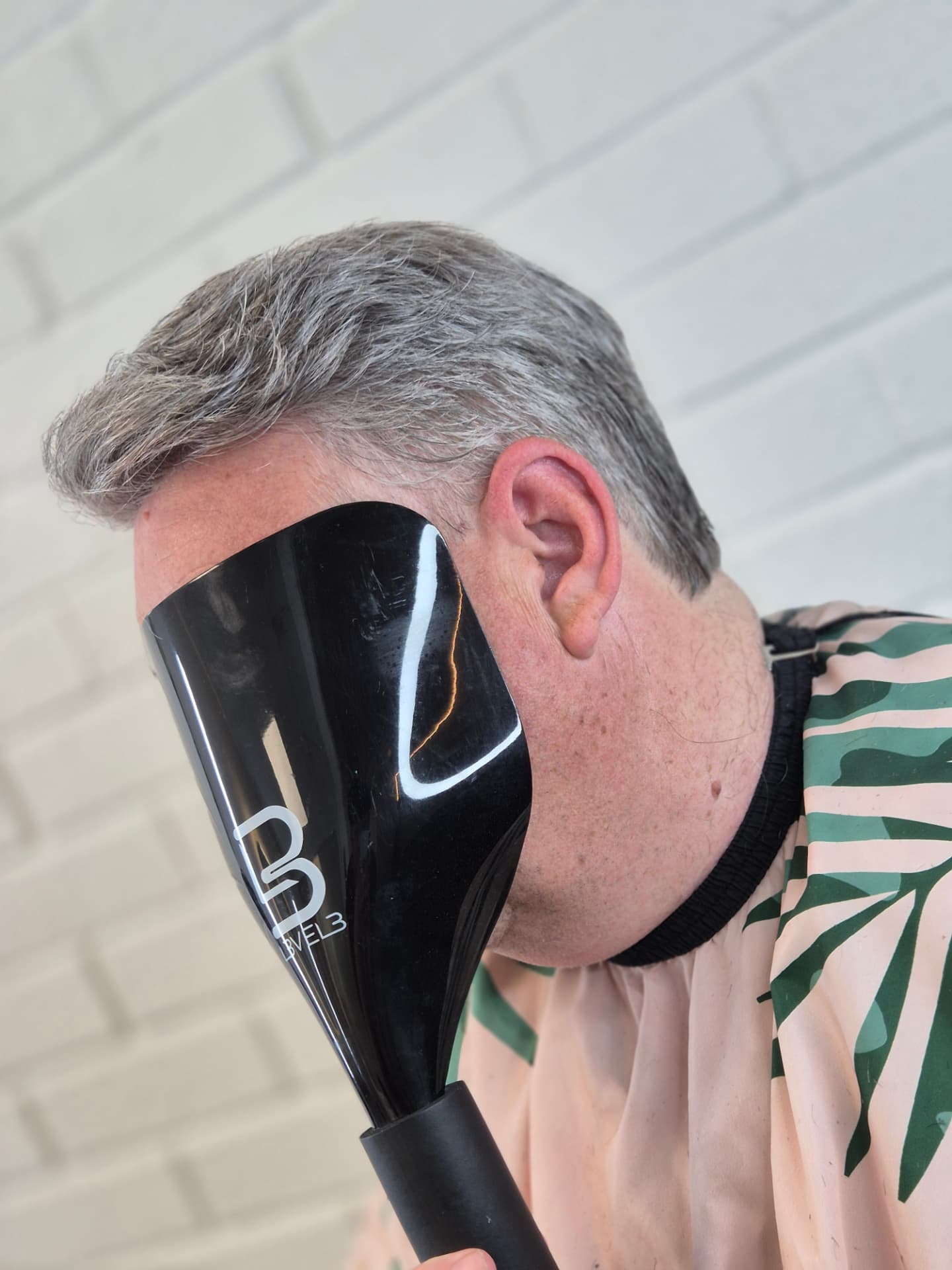 Silver grey hair system on a mature client