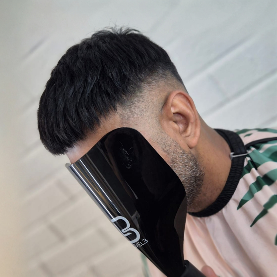Dark crop hair system finished with a skin fade